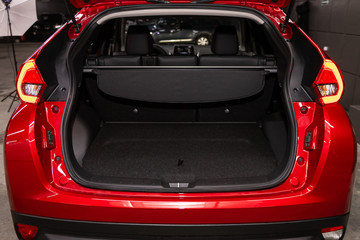 Rear view of a red car with an open trunk. Exterior of a modern car .