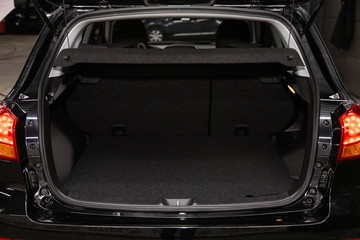Rear view of a black car with an open trunk. Exterior of a modern car .