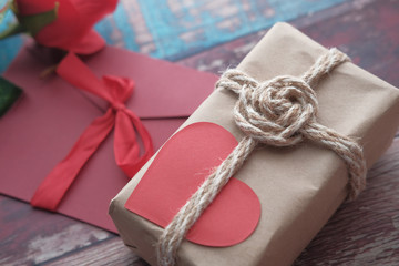 top view of gift box and envelope on red background 