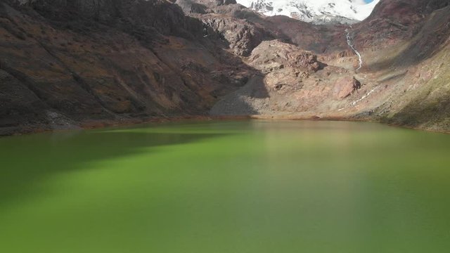 smooth fly over the green lake peruavian andes