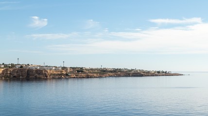 Fototapeta na wymiar Egypt, Sharm El Sheikh, Seaside coast, palm trees, houses, buildings against the blue sky.