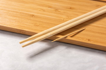 Disposable cutlery, toothpicks, chopsticks, napkins, plastic spoons on wooden trays