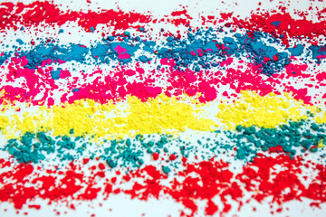 Colorful powder rows on white background. Colorful dust. Paint Holi, close up. Abstract multicolor image.