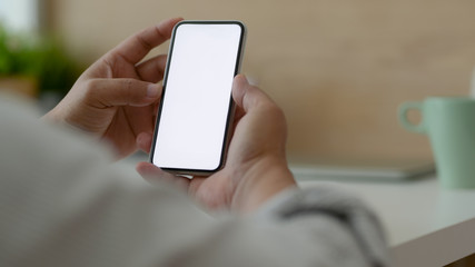 Cropped shot of male freelancer using blank screen smartphone