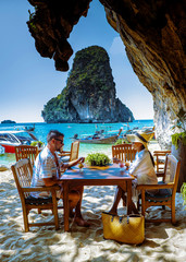 couple having an ice cream on the beach in Krabi Thailand, Railay beach with a beautiful backdrop...
