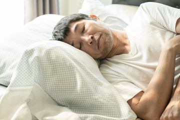 Senior asiam man sleeping on the bed