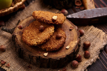 homemade oatmeal cookies with hazelnuts on wooden background