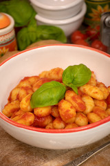 Gnocchi di patata, italian potato noodle with tomato sauce and basil, selective focus