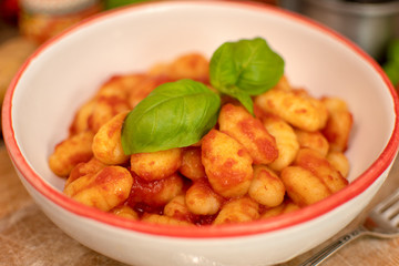 Gnocchi di patata, italian potato noodle with tomato sauce and basil, selective focus
