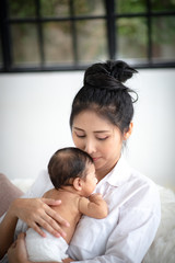 Fototapeta premium Mother is hugging and showing love to baby