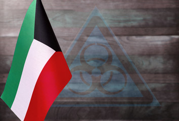 fragment of the flag of Kuwait on a blue background with a transparent biohazard sign