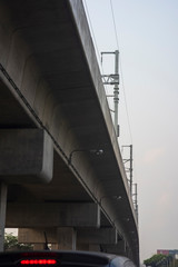 Electric pole system on the tollway seeing from a local road while waiting for a green light.