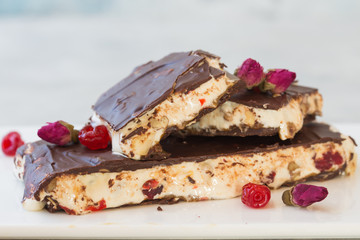 Delicious traditional Italian festive torrone or nougat with nuts on stone background. Holiday concept.
