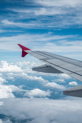 Obraz premium Look through the plane window and white cloud and blue sky