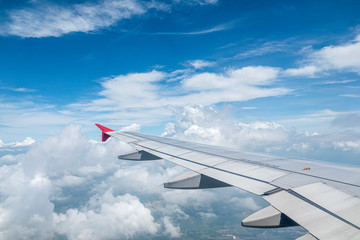 Fototapeta na wymiar Look through the plane window and white cloud and blue sky
