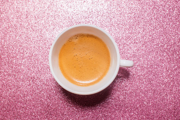 One cup hot fresh coffee on bright pink color paper