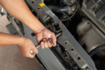 Hands of mechanic working in auto repair shop
