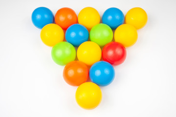 Colored plastic balls on white background