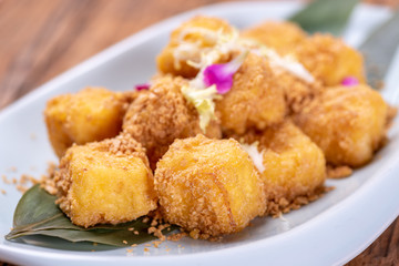 Golden Chinese dessert on a white plate
