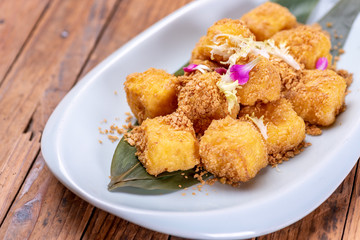 Golden Chinese dessert on a white plate