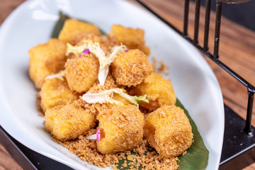 Golden Chinese dessert on a white plate
