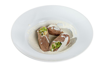 meatloaf, roll with vegetables and cheese stuffing with sour cream sauce on a plate, isolated on a white background. For a menu in the restaurant, bar Side view
