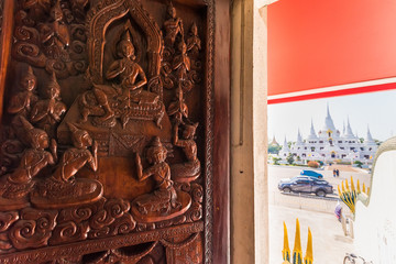 Samut Prakan, Thailand - February,23, 2020 : The image of Buddha's life is carved on the door of entrance the Buddhist temple Asokaram, Thailand.
