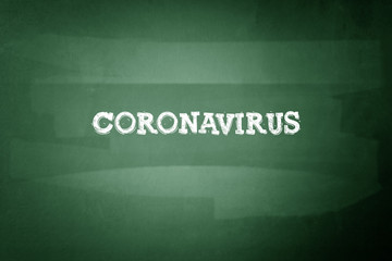 Coronavirus in chalk on a dark blackboard. Viruses. Epidemics.