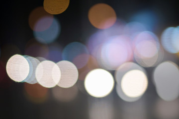 background of bokeh abstract colourful red, gold, blue and black glitter lights. defocused