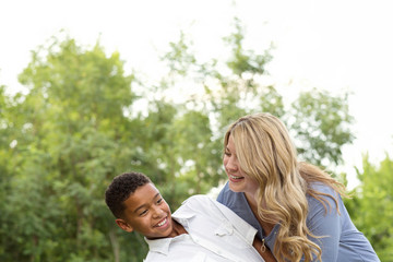 Fototapeta premium Mother and son laughing and playing at the park.