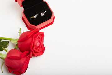 Diamond rings and gift boxes on roses