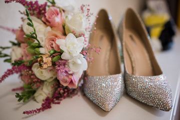 wedding shoes with a wedding bouquet