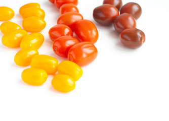 Vegetables, cherry tomatoes in three colors on a white background, red