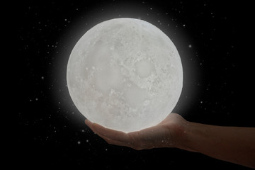 The moon hold by a human hand.