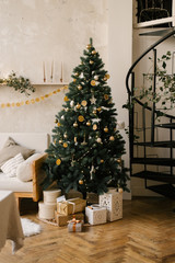 The decor of Christmas and New year. Christmas tree with toys and gifts