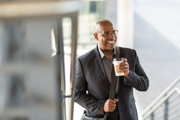 African American businessman drinking coffee on his way to work.