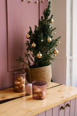 The decor of Christmas and New year. Pink kitchen with spruce branches