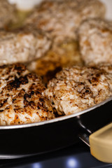 Meat cutlets are fried in a pan.  Cooking.