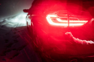 red tail light in a winter snow storm