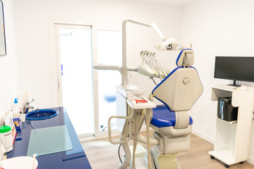 blue dentist armchair in dental clinic with white walls