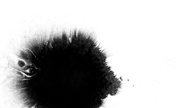 Black ink drops splatters spilling on white background