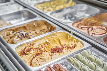 Caramel Gelato. Flavors various ice cream in Rome, Italy. Italian gelateria. Assortment of colorful gelato on cafe showcase. Natural fresh ice cream.