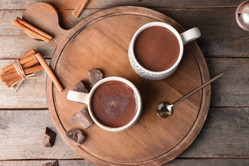 Cups of hot chocolate on wooden table