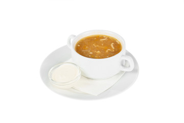 Soup with chicken, fish, cabbage soup, in plate isolated white and sour cream, on a napkin. Serving dishes in a cafe, restaurant, for a menu. Side view
