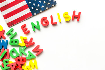 English text near American flag and letters on white background top-down copy space