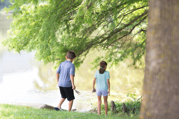 Portrait of happy siblings laughing and playing outside