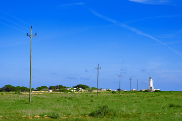 Fototapeta na wymiar Power line to the Lighthouse of El Pilar de la Mola, Formentera, Balearic Islands