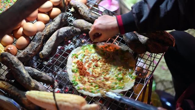 4K Making Banh Trang Nuong, flat rice crackers grilled in southern Vietnam,Street food at Vietnam in the night market.