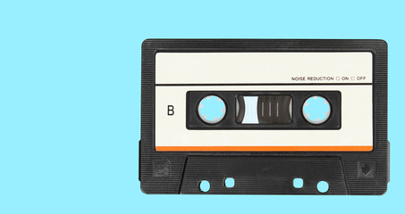 Retro audio tape cassette on a blue background. Top view