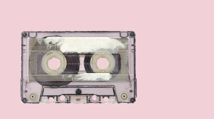 Retro audio tape cassette on a pink background. Top view
